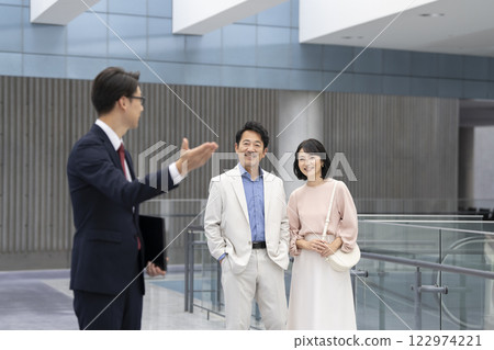 Salesman and a couple in their 50s viewing a property 122974221