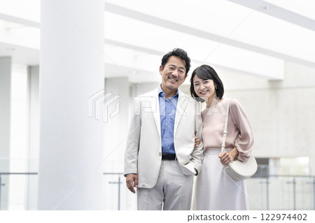 A couple in their 50s smiling at the camera A couple in their 50s smiling at the camera 122974402