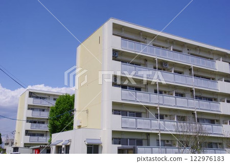 Real estate image: Five-story mid-rise housing complex on a sunny day Real estate image: Five-story mid-rise housing complex on a sunny day 122976183