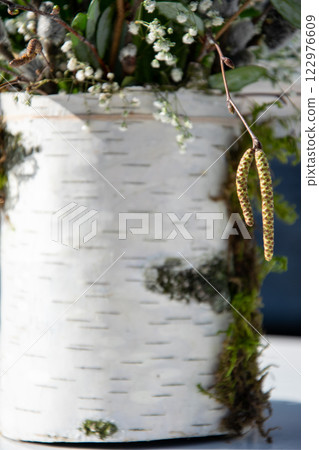 A beautifully arranged planter displays vibrant plants and a touch of nature, highlighting earthy textures and colors beautifully 122976609
