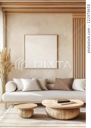 Modern minimalist living room with empty frame, beige sofa, wooden coffee table, and neutral decor in natural light. 122978658