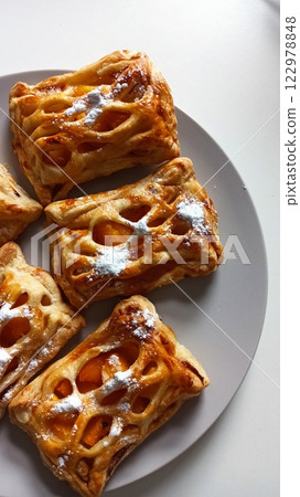 Golden puff pastries with fruit filling Golden puff pastries with fruit filling 122978848