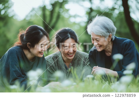 An elderly mother with her daughters laughing 122978859