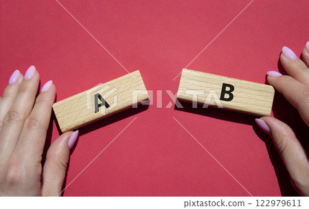 Plan A and Plan B symbol. Concept word Plan A and Plan B on wooden blocks. Businessman hand. Beautiful red background. Plan A and Plan B concept. Copy space Plan A and Plan B symbol. Concept word Plan A and Plan B on wooden blocks. Businessman hand. Beautiful red background. Plan A and Plan B concept. Copy space 122979611