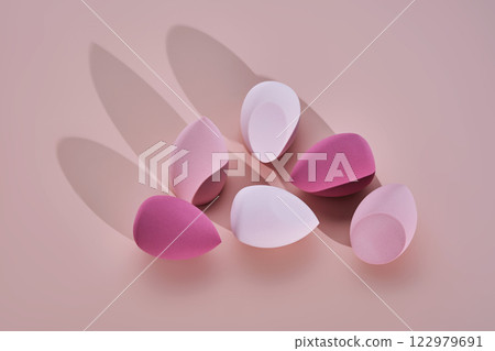 A set of makeup sponges on a pink background. 122979691