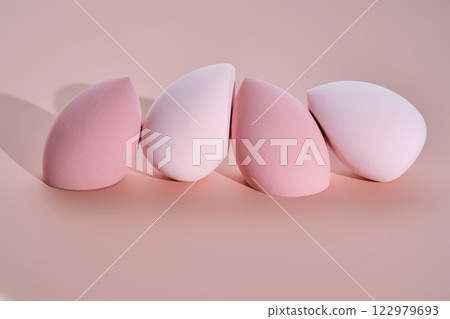 A set of makeup sponges on a pink background. A set of makeup sponges on a pink background. 122979693
