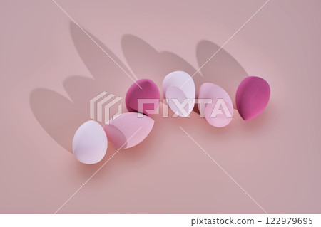 A set of makeup sponges on a pink background. A set of makeup sponges on a pink background. 122979695