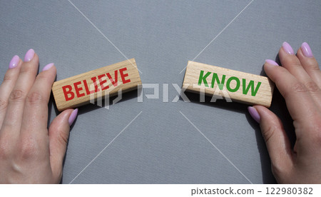 Believe or Know symbol. Concept word Believe or Know on wooden blocks. Businessman hand. Beautiful grey background. Business and Believe or Know concept. Copy space 122980382