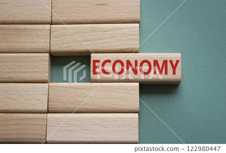 Economy symbol. Concept word Economy on wooden blocks. Beautiful grey green background. Business and Economy concept. Copy space. 122980447