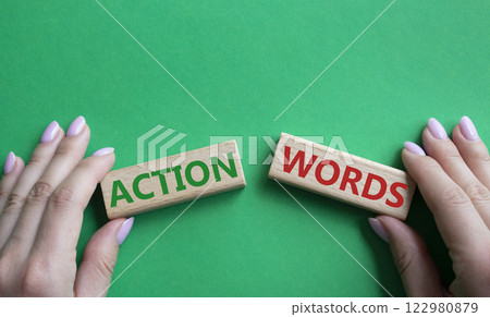 Action or words symbol. Concept word Action or words on wooden blocks. Businessman hand. Beautiful green background. Business and Action or words concept. Copy space 122980879