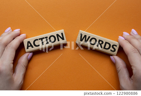 Action or words symbol. Concept word Action or words on wooden blocks. Businessman hand. Beautiful orange background. Business and Action or words concept. Copy space 122980886