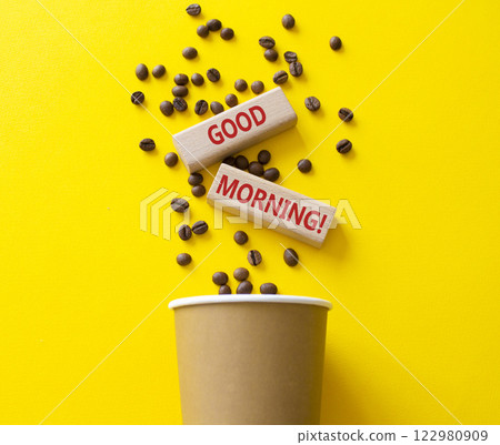 Good Morning symbol. Concept word Good Morning on wooden blocks. Beautiful yellow background with coffee cup. Business and Good Morning concept. Copy space 122980909