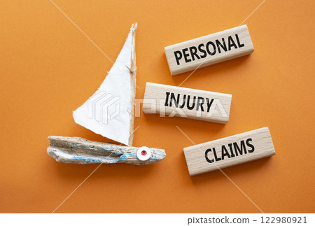 Personal Injury Claims symbol. Concept words Personal Injury Claims on wooden blocks. Beautiful orange background with boat. Business concept and Personal Injury Claims. Copy space. Personal Injury Claims symbol. Concept words Personal Injury Claims on wooden blocks. Beautiful orange background with boat. Business concept and Personal Injury Claims. Copy space. 122980921