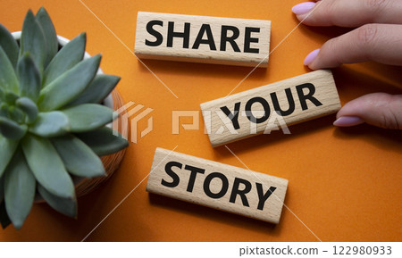 Share your story symbol. Wooden blocks with words Share your story. Beautiful orange background with succulent plant. Businessman hand. Business and Share your story concept. Copy space. Share your story symbol. Wooden blocks with words Share your story. Beautiful orange background with succulent plant. Businessman hand. Business and Share your story concept. Copy space. 122980933