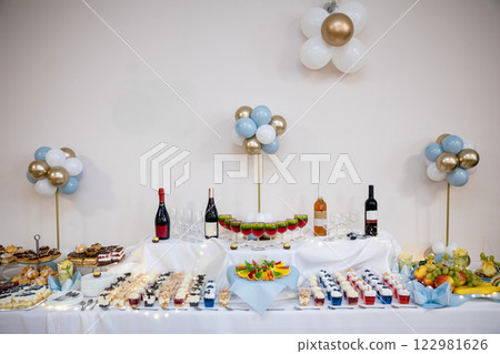An Elegant Party Table Setup Featuring an Array of Delicious Treats Alongside Drinks 122981626