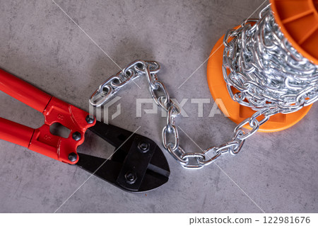 Professional Tools Heavyduty Bolt Cutters and Strong Chain on a Work Surface Ready for Use Professional Tools Heavyduty Bolt Cutters and Strong Chain on a Work Surface Ready for Use 122981676