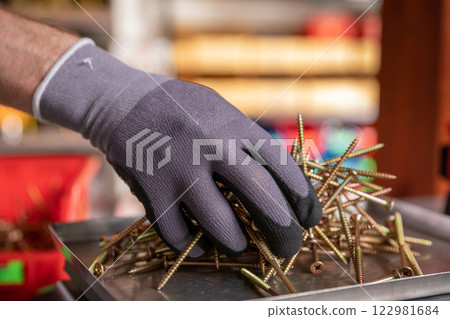 Hand Sorting Various Types of Metal Fasteners in a Dedicated Workshop Setting Environments Hand Sorting Various Types of Metal Fasteners in a Dedicated Workshop Setting Environments 122981684