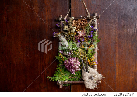 Vibrant and Colorful Nature Wall Art Adorned with Dried Flowers and Soft Green Moss Accents 122982757