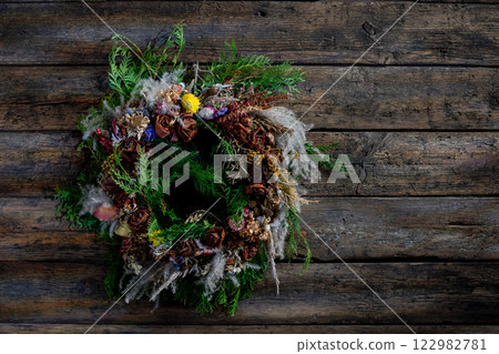 Beautiful Natural Rustic Wreath Decor Graced on a Charming Wooden Background Surface 122982781