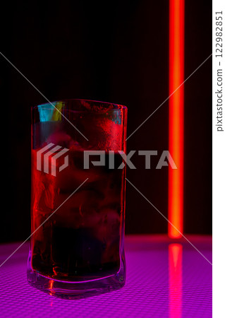 Chic Cocktail Glass Illuminated with Colorful and Vibrant Lights for a Stunning Effect Chic Cocktail Glass Illuminated with Colorful and Vibrant Lights for a Stunning Effect 122982851
