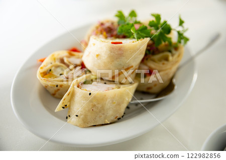 Deliciously Rolled Savory Wraps, Expertly Crafted with Fresh Herbs and Flavorful Fillings Deliciously Rolled Savory Wraps, Expertly Crafted with Fresh Herbs and Flavorful Fillings 122982856