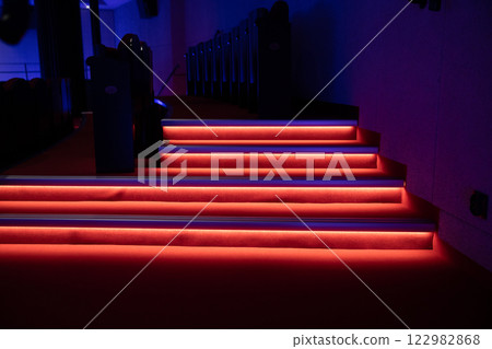 An Illuminated Modern Staircase Featuring Striking Red and Blue Lights for a Unique Ambiance 122982868