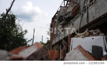View to destroyed residential buildings at Kharkivska oblast. Ruined houses after bomb attacks on ukrainian territory from russia army. Consequences of russian invasion of Ukraine. Slow motion 122983264