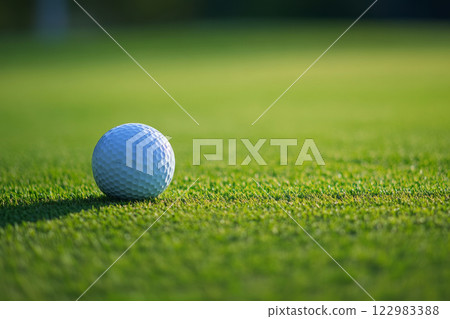 Golf ball on lush green course Golf ball on lush green course 122983388