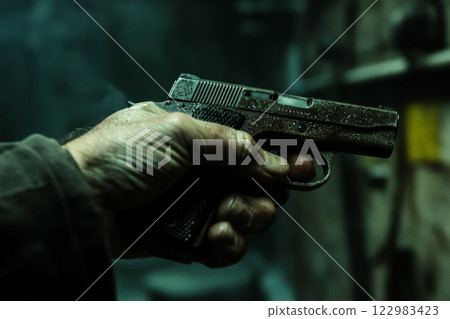 Hand holding gun in night Hand holding gun in night 122983423
