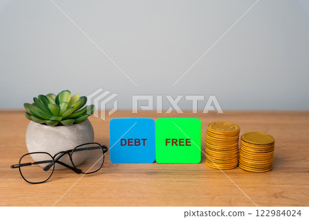Debt free notes concept. Not owing lump sums of money that you pay off month to month. Business and finance. Coins, glasses and succulents Debt free notes concept. Not owing lump sums of money that you pay off month to month. Business and finance. Coins, glasses and succulents 122984024