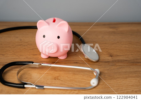 Red piggy bank pig and stethoscope. Healthcare checkup and savings money for medical insurance. The concept of medicine and finance 122984041