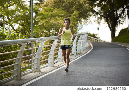 young asian woman jogging running in park young asian woman jogging running in park 122984260