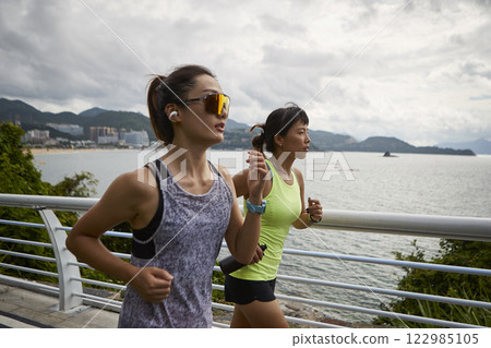 young asian women running jogging outdoors young asian women running jogging outdoors 122985105
