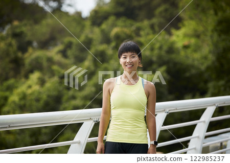 outdoor portrait of a young asian woman athlete outdoor portrait of a young asian woman athlete 122985237