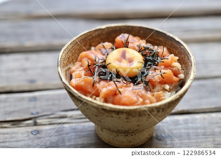 Salmon yukke rice bowl topped with egg yolk Salmon yukke rice bowl topped with egg yolk 122986534