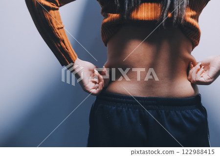 Asian Woman Pinching Her Belly Fat With Left Hand 122988415