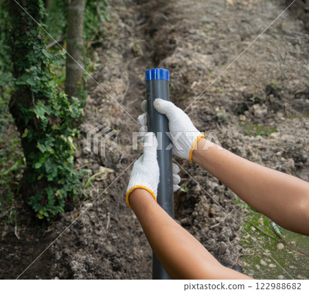 Pipe contractor install new HDPE pipes under the ground in village, Pipe contractor install new HDPE pipes under the ground in village, 122988682