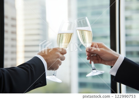 Two Professionals in Suits Toasting with Champagne Glasses Together 122990753