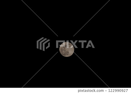 Full moon floating in the night sky 122990927