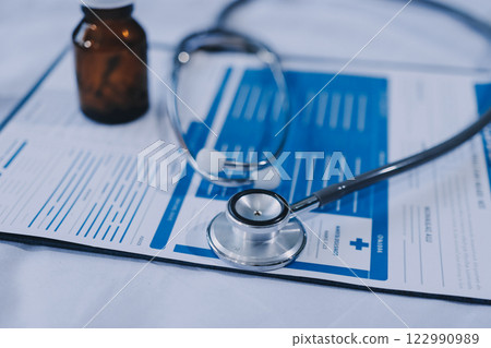 stethoscope on a report stethoscope on a clipboard stethoscope on a book stethoscope on a report stethoscope on a clipboard stethoscope on a book 122990989