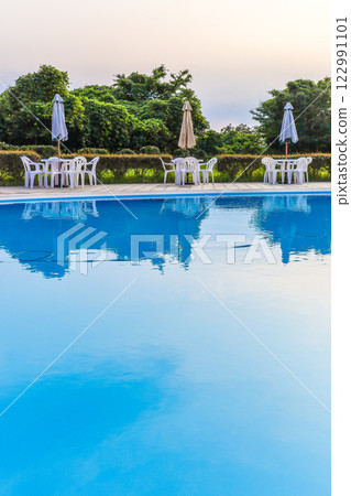 Outdoor pool water surface and poolside Outdoor pool water surface and poolside 122991101
