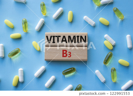 Vitamin B3 symbol. Concept word Vitamin B3 on wooden blocks. Beautiful blue background with pills. Medicine and Vitamin B3 concept. Copy space Vitamin B3 symbol. Concept word Vitamin B3 on wooden blocks. Beautiful blue background with pills. Medicine and Vitamin B3 concept. Copy space 122991553