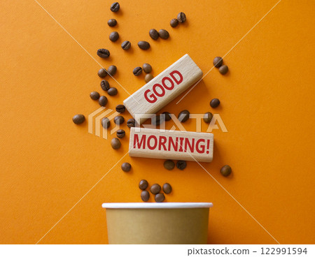 Good Morning symbol. Concept word Good Morning on wooden blocks. Beautiful orange background with coffee cup. Business and Good Morning concept. Copy space 122991594