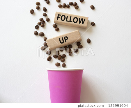 Follow up symbol. Concept word Follow up on wooden blocks. Beautiful white background with coffee cup. Business and Follow up concept. Copy space 122991604