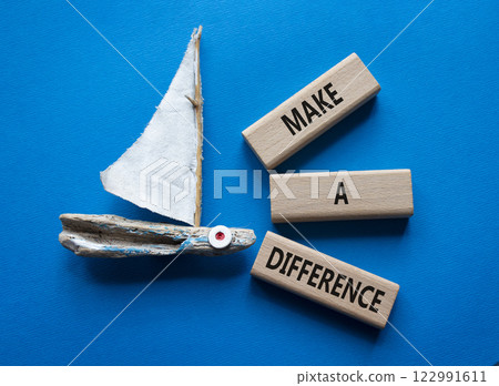 Make a difference symbol. Concept words Make a difference on wooden blocks. Beautiful blue background with boat. Business concept and Make a difference. Copy space. 122991611
