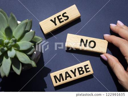Yes No Maybe symbol. Concept words Yes No Maybe on wooden blocks with succulent plant. Businessman hand. Beautiful deep blue background. Business and Yes No Maybe concept. Copy space. Yes No Maybe symbol. Concept words Yes No Maybe on wooden blocks with succulent plant. Businessman hand. Beautiful deep blue background. Business and Yes No Maybe concept. Copy space. 122991635