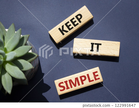 Keep it Simple symbol. Concept words Keep it Simple on wooden blocks. Beautiful deep blue background with succulent plant. Business and Keep it Simple concept. Copy space. Keep it Simple symbol. Concept words Keep it Simple on wooden blocks. Beautiful deep blue background with succulent plant. Business and Keep it Simple concept. Copy space. 122991647