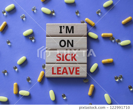 Sick leave symbol. Concept word I am on sick leave on wooden blocks. Beautiful purple background with pills. Medicine and I am on sick leave concept. Copy space Sick leave symbol. Concept word I am on sick leave on wooden blocks. Beautiful purple background with pills. Medicine and I am on sick leave concept. Copy space 122991710