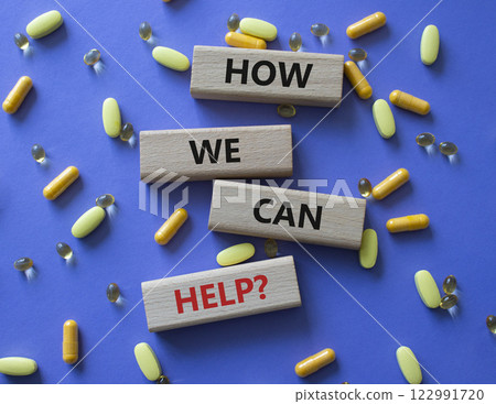 How we can help symbol. Concept word How we can help on wooden blocks. Beautiful purple background with pills. Medicine and How we can help concept. Copy space How we can help symbol. Concept word How we can help on wooden blocks. Beautiful purple background with pills. Medicine and How we can help concept. Copy space 122991720