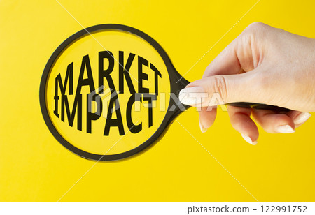 Market impact symbol. Concept word Market impact on magnifying glass. Beautiful yellow background. Businessman hand. Business and Market impact concept. Copy space. 122991752